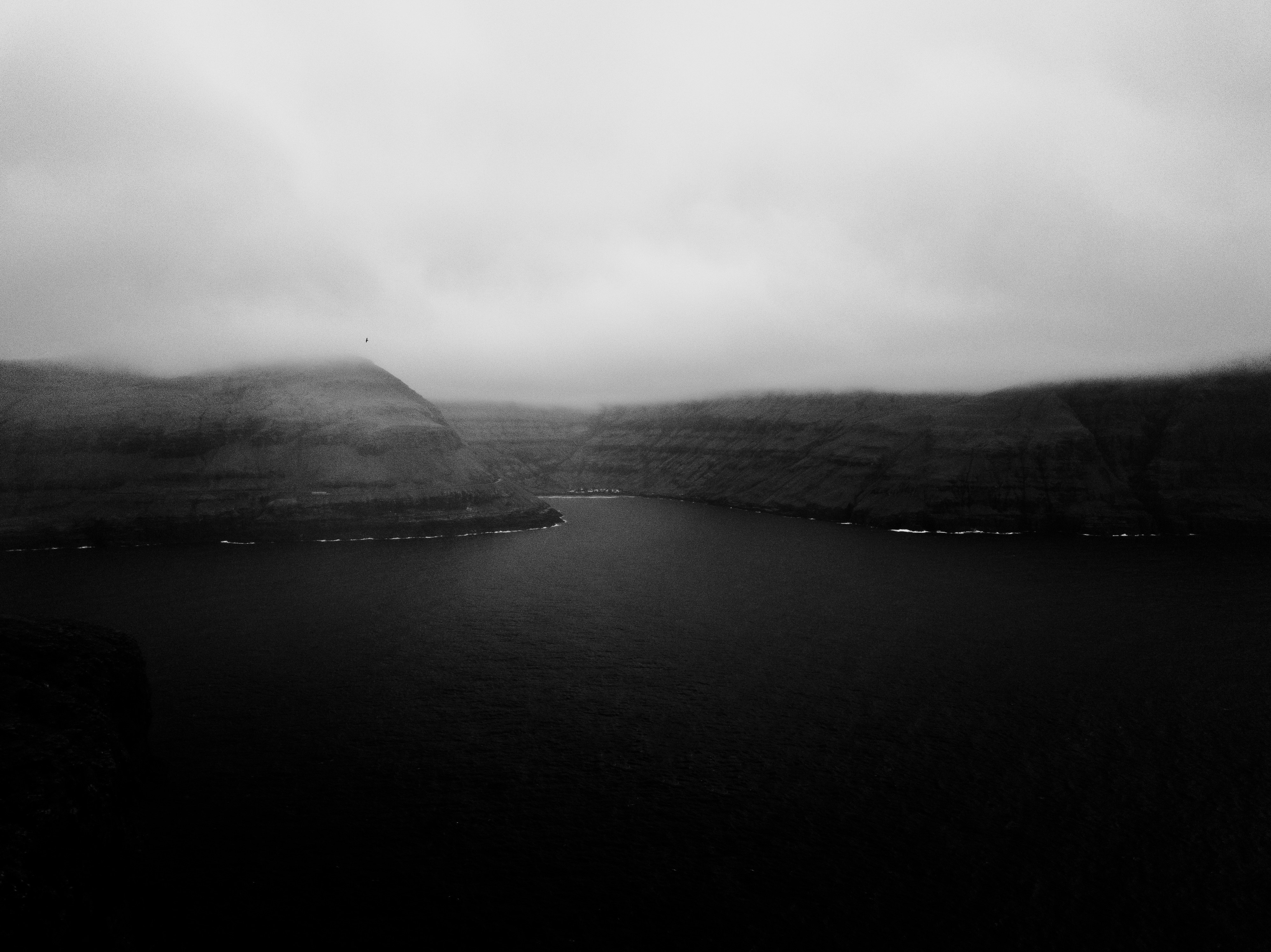 grayscale photography of river near mountain